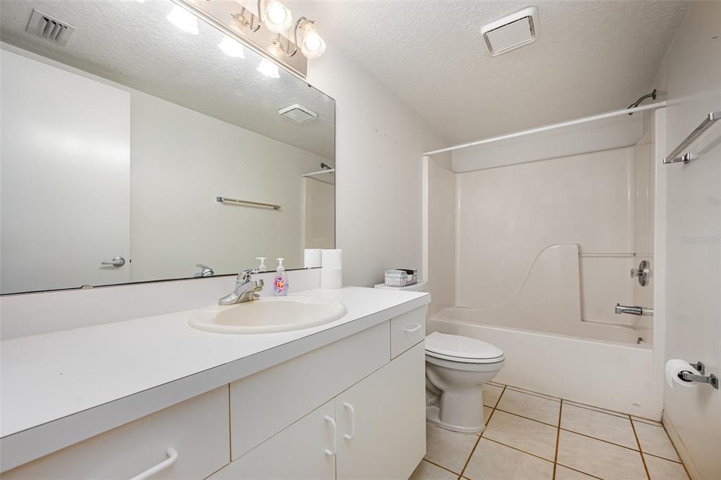 1420 Huntington Lane, Unit 2502 Rockledge, FL 32955 - Photo 14 of 26 a bathroom with a sink a toilet and shower