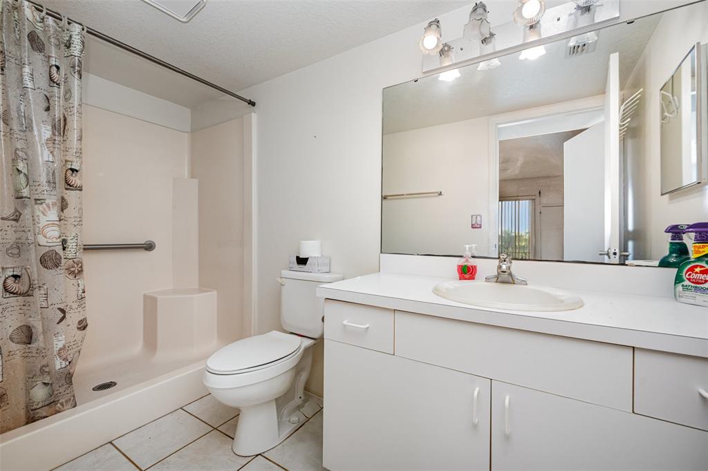 1420 Huntington Lane, Unit 2502 Rockledge, FL 32955 - Photo 16 of 23 a bathroom with a sink a toilet and shower