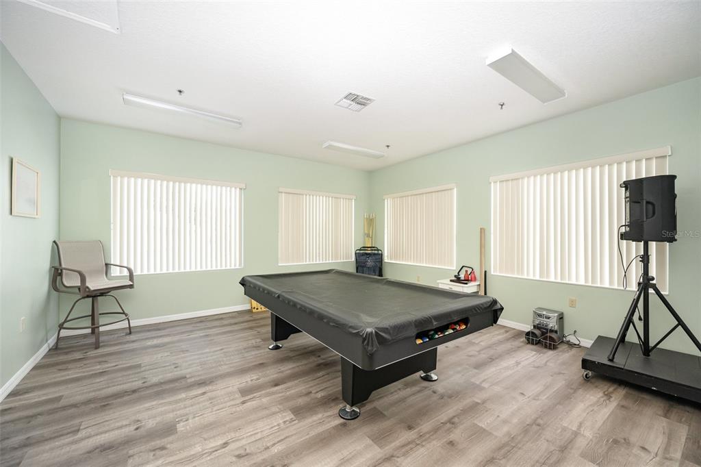 1420 Huntington Lane, Unit 2502 Rockledge, FL 32955 - Photo 23 of 26 a living room with a table chairs and a window