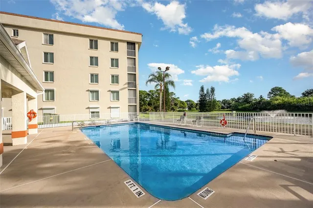 a view of swimming pool with outdoor seating and plants