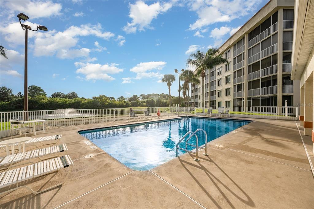 1420 Huntington Lane, Unit 2502 Rockledge, FL 32955 - Photo 25 of 26 a view of a swimming pool with a lounge chairs