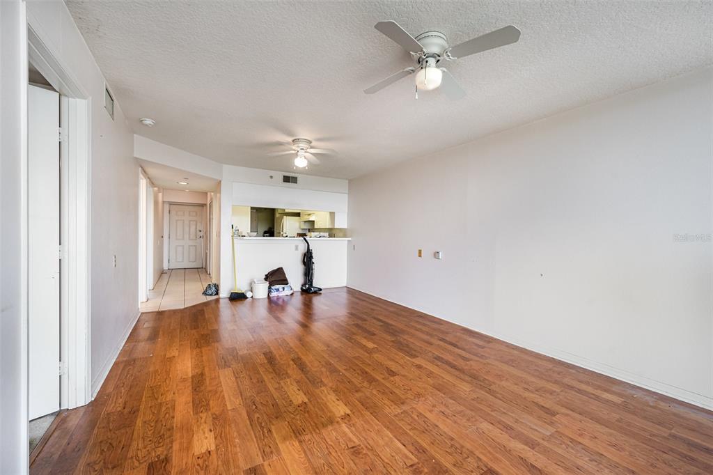 1420 Huntington Lane, Unit 2502 Rockledge, FL 32955 - Photo 4 of 26 wooden floor in an empty room with a window