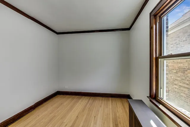 a view of a room with wooden floor and iron stairs