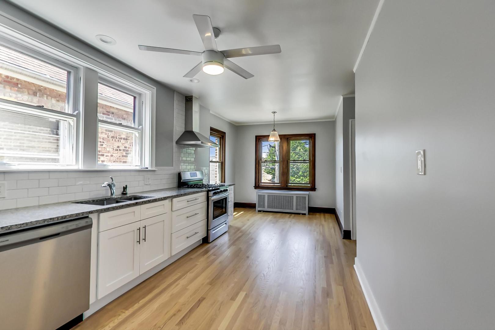 1814 Wesley Avenue, Unit 1 Berwyn, IL 60402 - Photo 8 of 26 a kitchen with granite countertop a sink a counter space appliances and windows