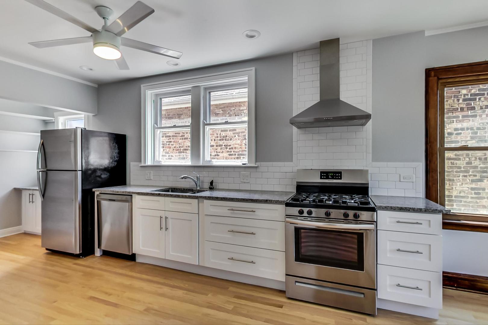1814 Wesley Avenue, Unit 1 Berwyn, IL 60402 - Photo 9 of 26 a kitchen with stainless steel appliances a stove a sink and a refrigerator