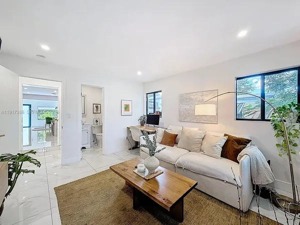 a living room with furniture and wooden floor