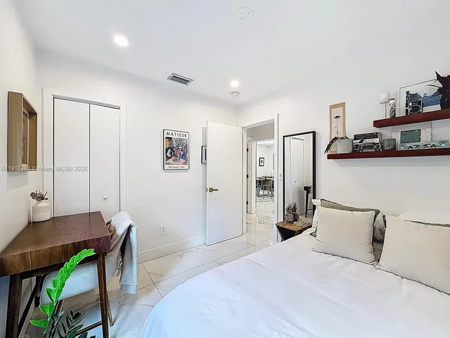 a bedroom with a bed and a table in it