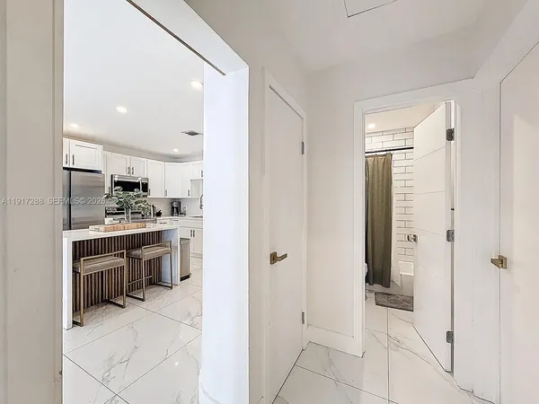 a kitchen with stainless steel appliances a refrigerator and a sink