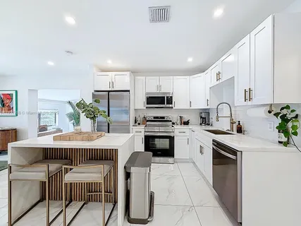 a kitchen with cabinets stainless steel appliances and a counter top space