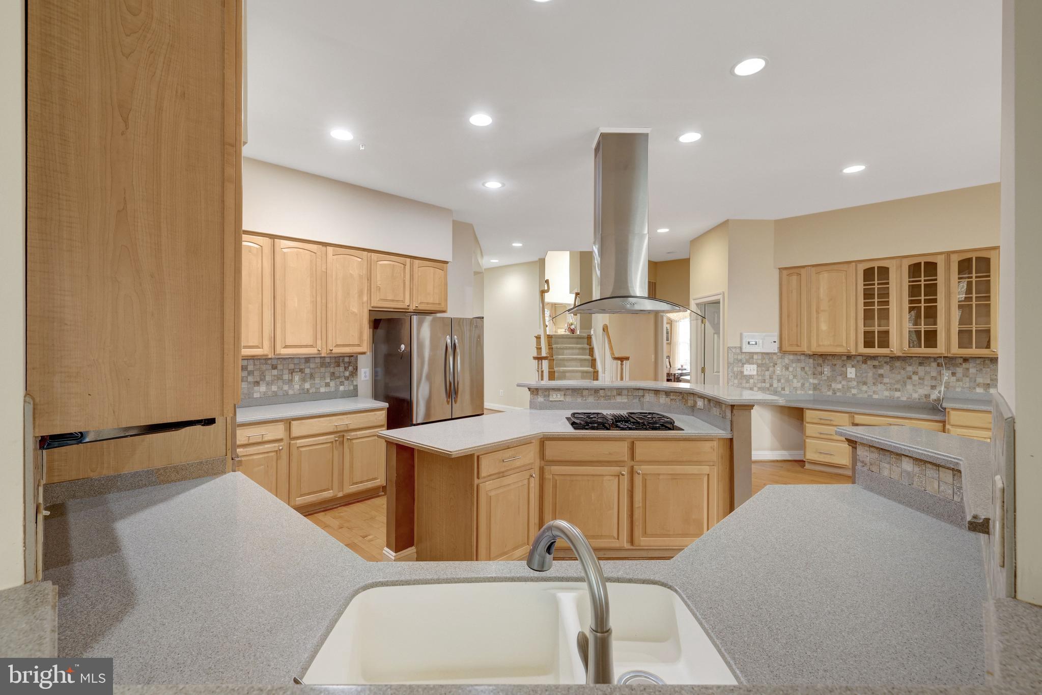 20443 Cliftons Point Street Sterling, VA 20165 - Photo 13 of 37 a kitchen with stainless steel appliances kitchen island granite countertop a sink and cabinets