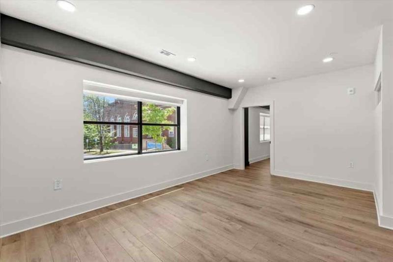 108 Park Place, Unit 107 Decatur, GA 30030 - Photo 12 of 31 a view of an empty room with wooden floor and a window