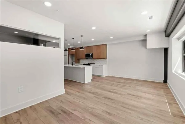 a view of kitchen with microwave and refrigerator