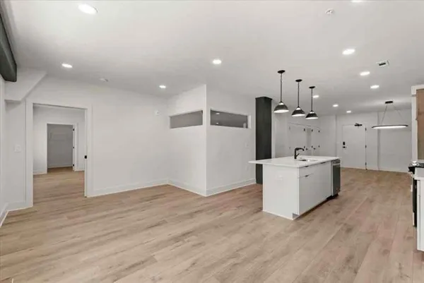 a view of a kitchen with a sink and a large window