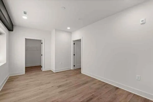 a view of hallway with wooden floor