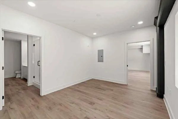 wooden floor in an empty room with a window