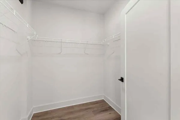 a view of a room with wooden floor