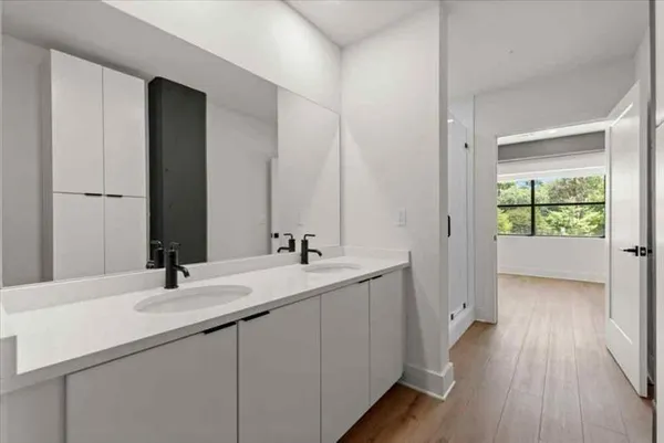 a bathroom with a double vanity sink and mirror