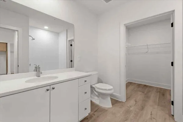 a bathroom with a sink a toilet a shower and a mirror