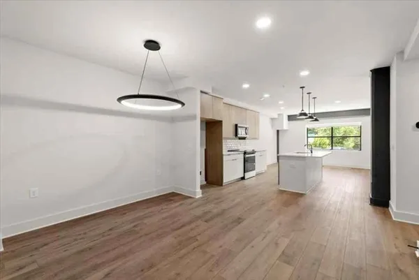 a view of a kitchen with furniture and wooden floor