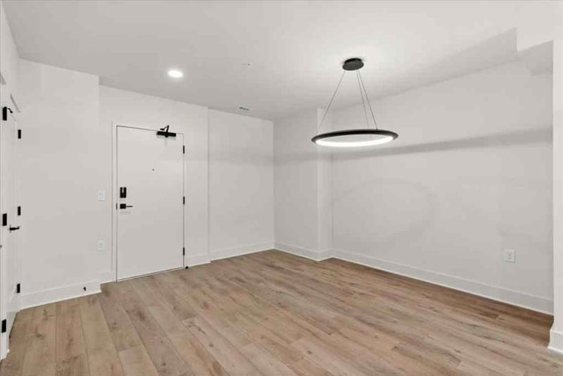 108 Park Place, Unit 107 Decatur, GA 30030 - Photo 5 of 31 a view of a room with a ceiling fan and wooden floor