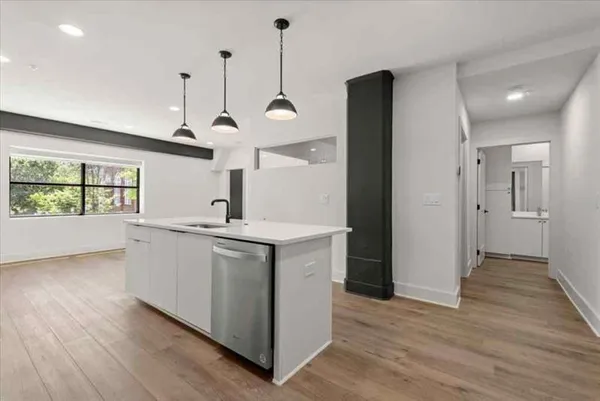 a kitchen with a sink a refrigerator and window