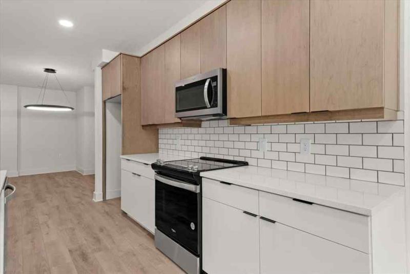 108 Park Place, Unit 107 Decatur, GA 30030 - Photo 10 of 31 a kitchen with granite countertop a stove sink and cabinets