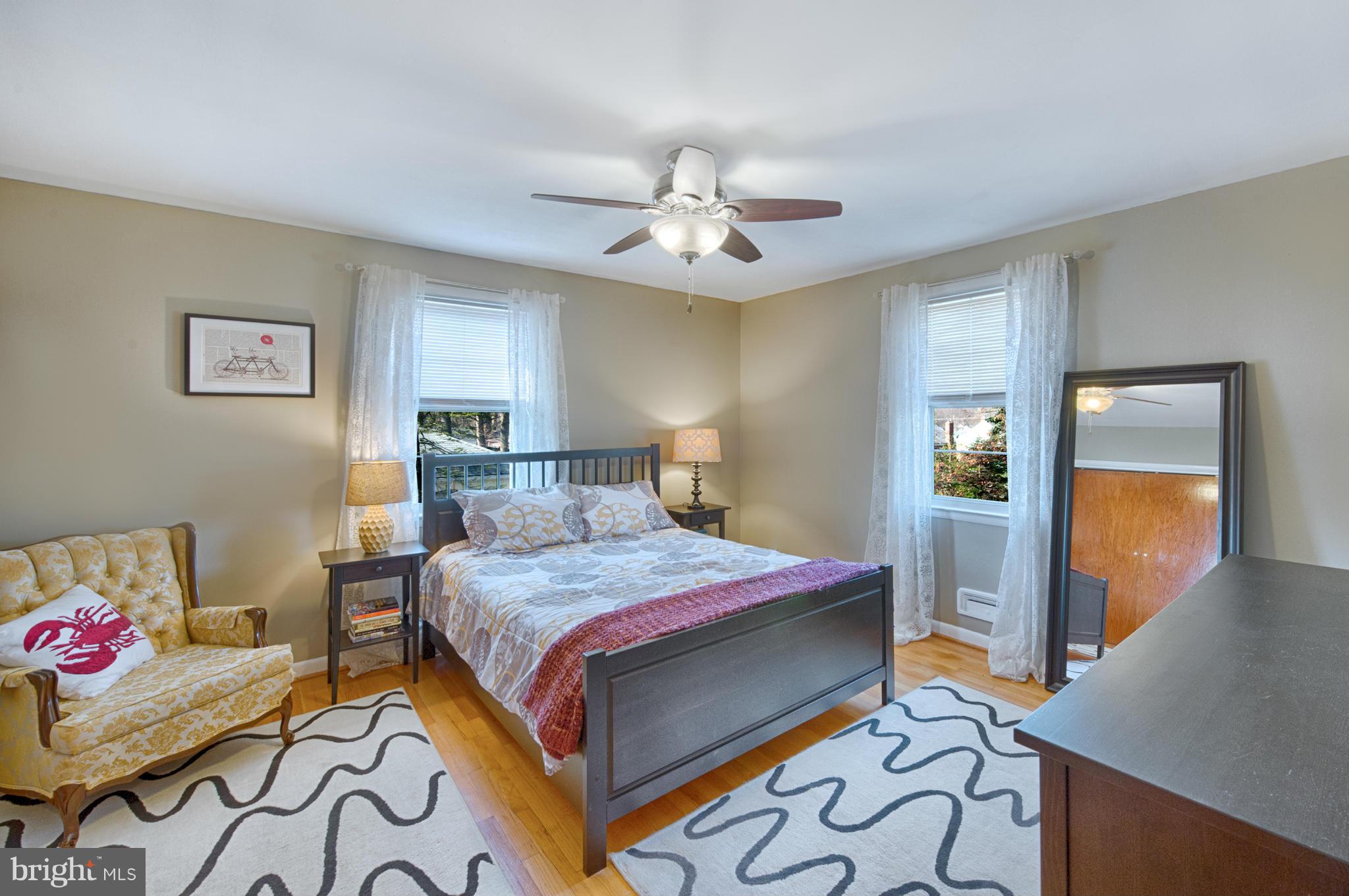 8110 Hillendale Road Baltimore, MD 21234 - Photo 18 of 30 a bedroom with a bed and a chandelier