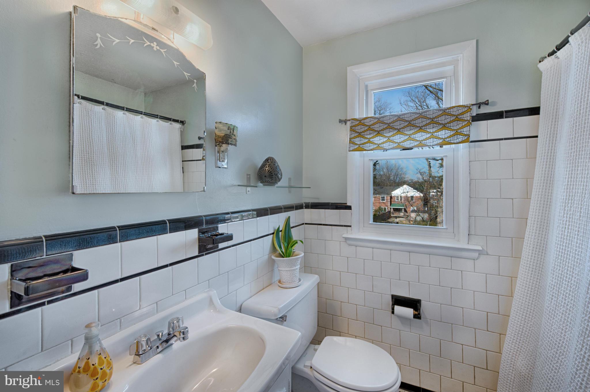 8110 Hillendale Road Baltimore, MD 21234 - Photo 21 of 30 a bathroom with a toilet sink and mirror