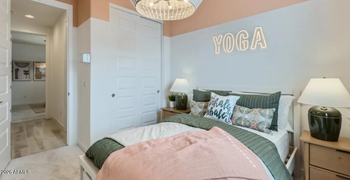 15602 West Miami Street Goodyear, AZ 85338 - Photo 12 of 25 a bedroom with a bed and wooden floor