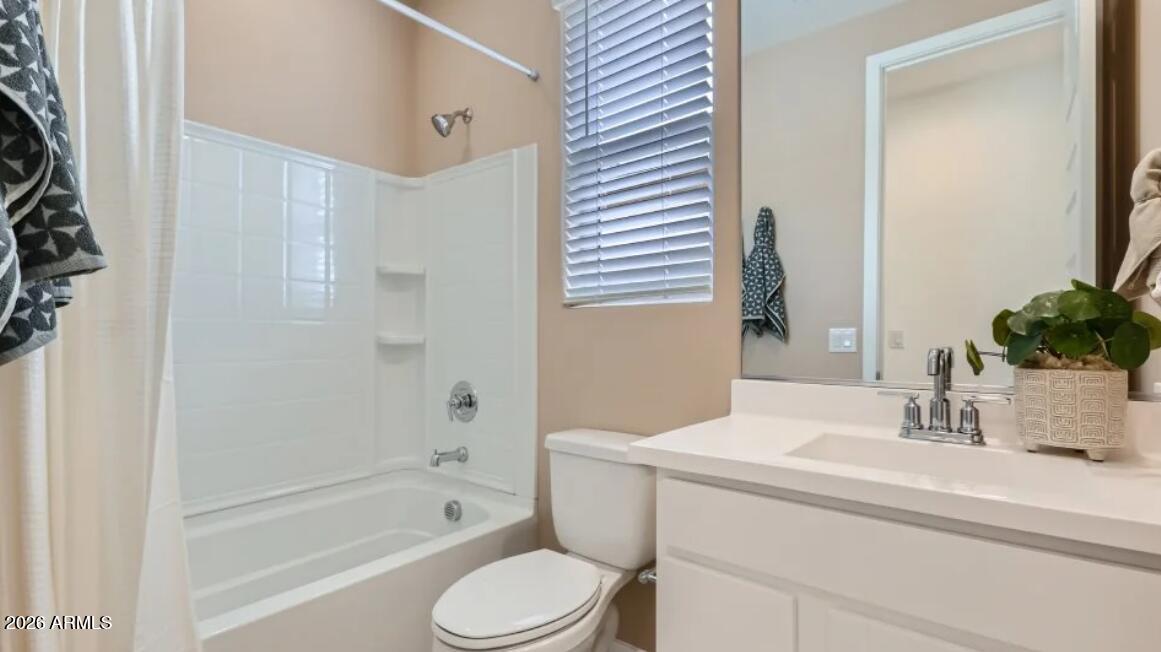 15602 West Miami Street Goodyear, AZ 85338 - Photo 14 of 25 a bathroom with a sink a toilet a tub and shower