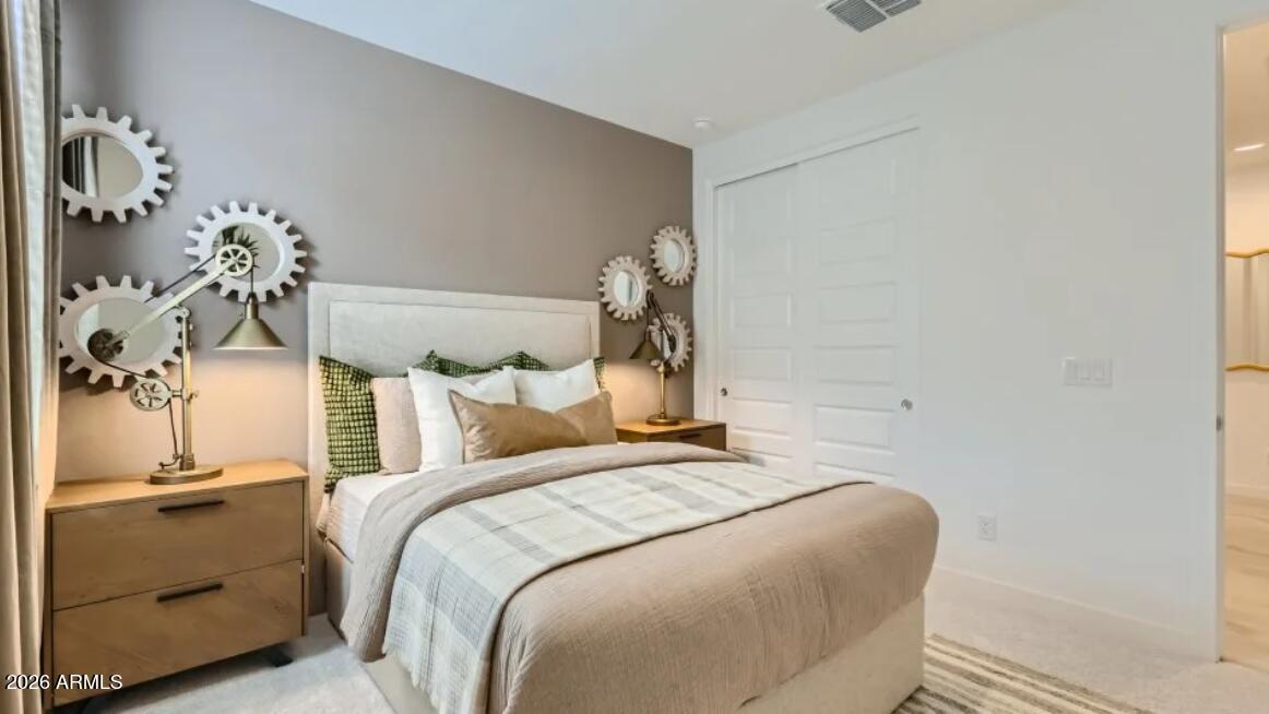 15602 West Miami Street Goodyear, AZ 85338 - Photo 18 of 25 a bedroom with a bed and a mirror