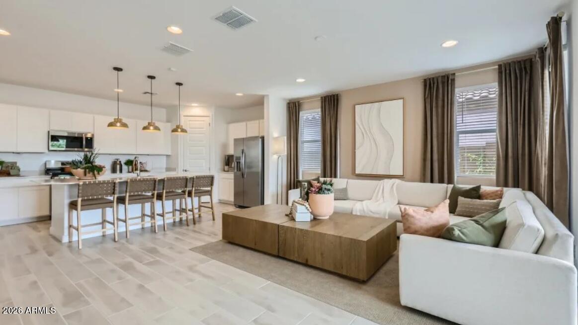 15602 West Miami Street Goodyear, AZ 85338 - Photo 5 of 25 a living room with furniture kitchen area and a large window