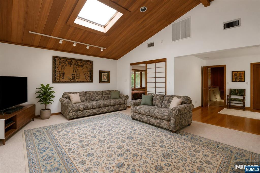34 Cambridge Way Alpine, NJ 07620 - Photo 23 of 48 a living room with furniture and a flat screen tv