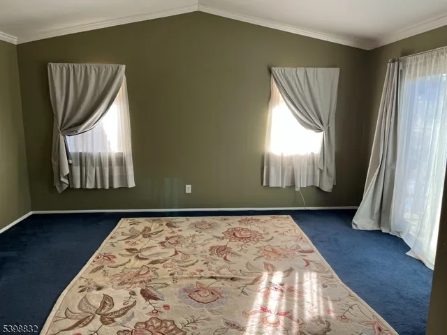 a view of an empty room and wooden floor