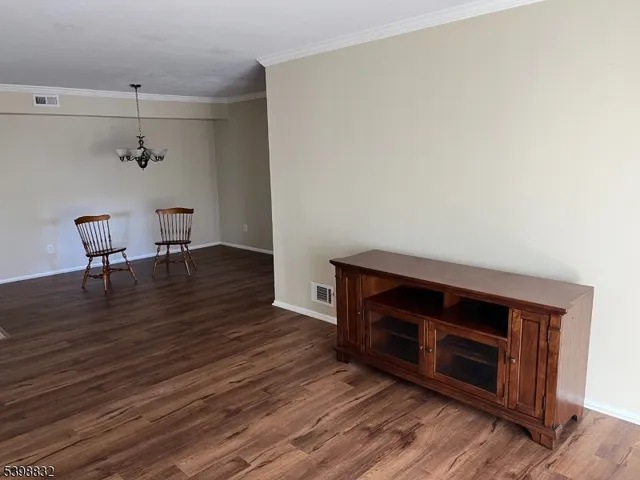 a living room with wooden floors and a fireplace