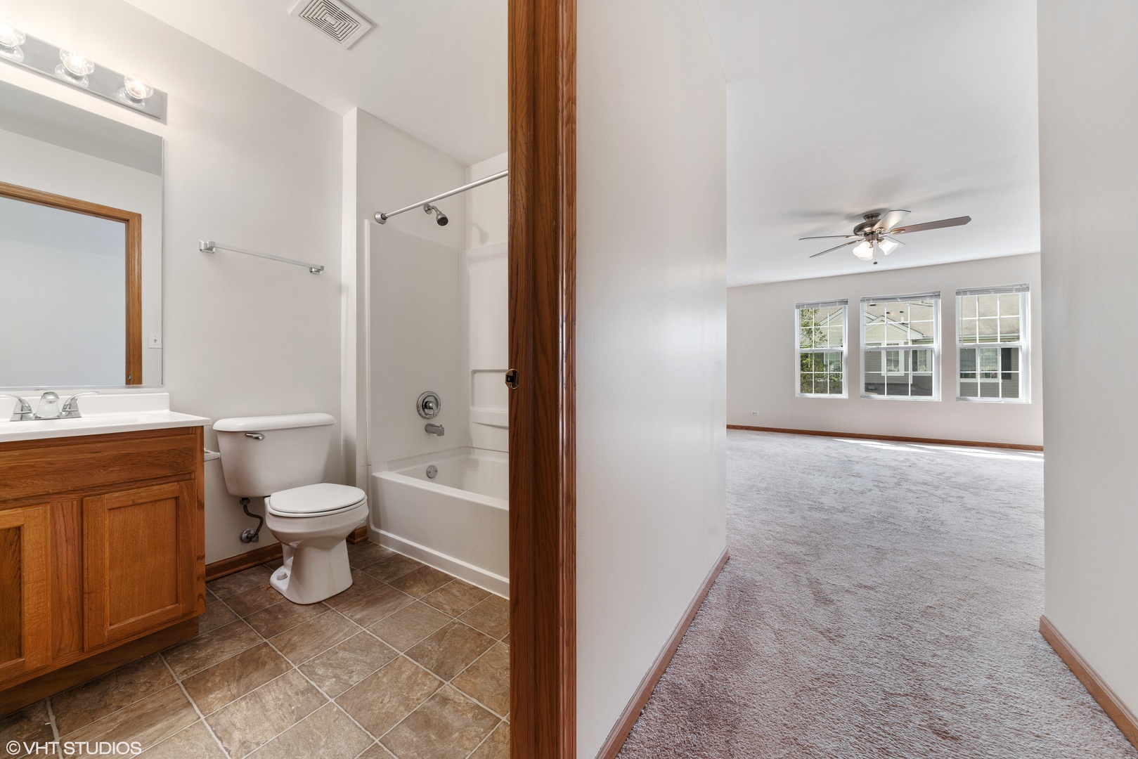 131 Springbrook Trail South Oswego, IL 60543 - Photo 15 of 16 a bathroom with a toilet a sink and a large mirror