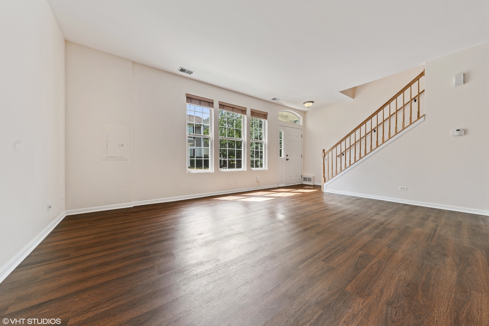 131 Springbrook Trail South Oswego, IL 60543 - Photo 2 of 16 a view of an empty room with wooden floor and a window