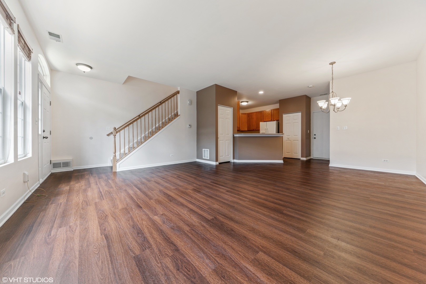 131 Springbrook Trail South Oswego, IL 60543 - Photo 4 of 16 a view of a room with wooden floor and windows