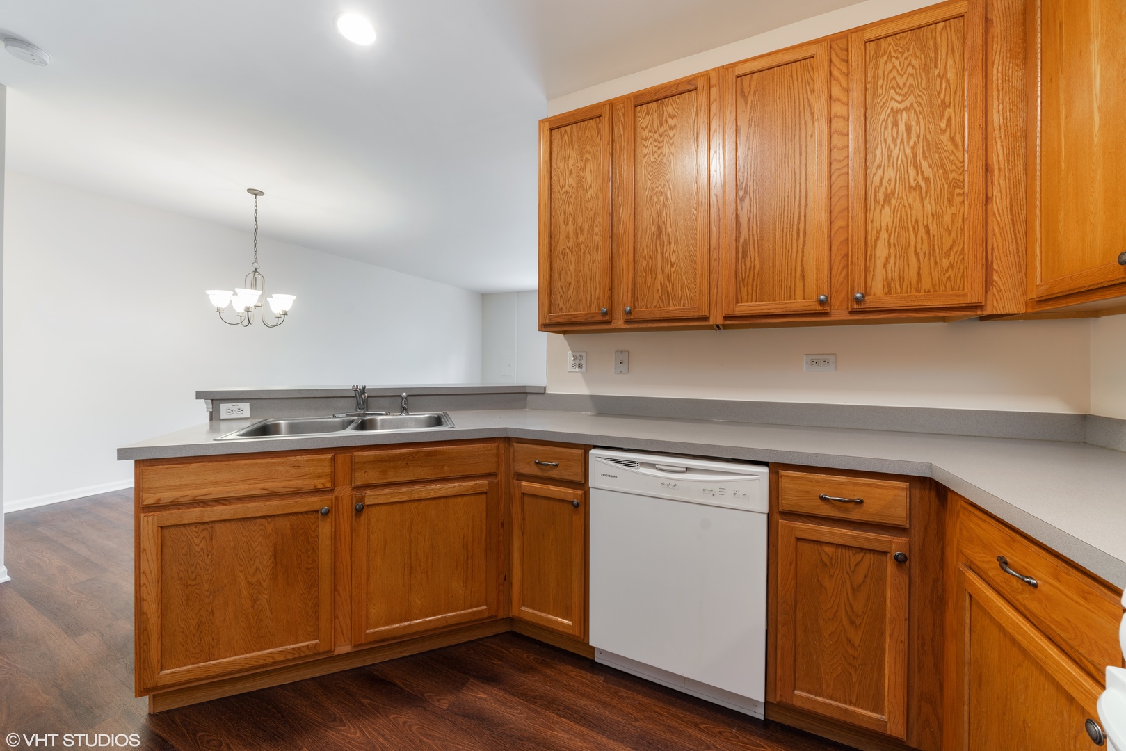 131 Springbrook Trail South Oswego, IL 60543 - Photo 6 of 16 a kitchen with granite countertop wooden cabinets and white appliances