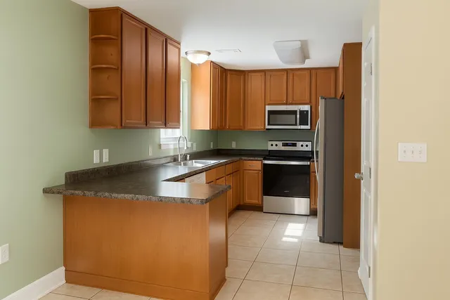 a kitchen with stainless steel appliances granite countertop a sink and a stove