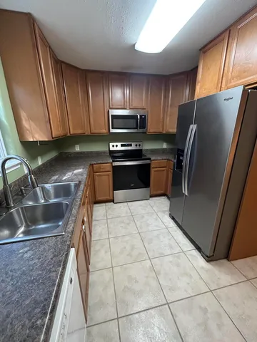 a kitchen with stainless steel appliances granite countertop a sink and cabinets