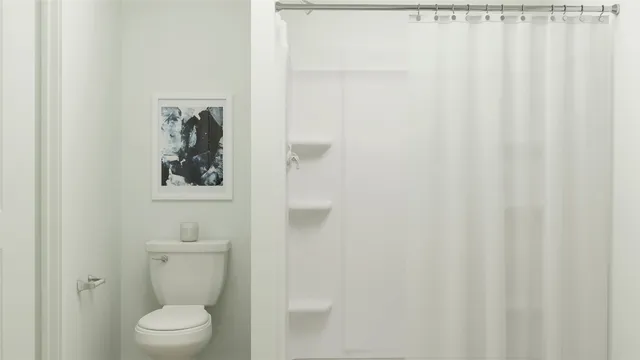 a white toilet sitting next to a white sink
