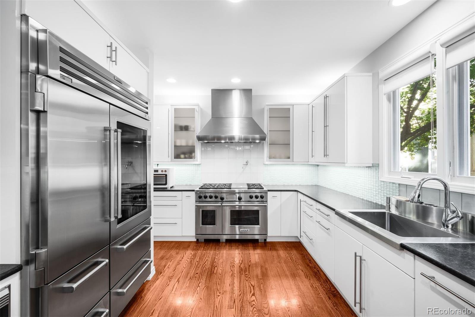 361 Detroit Street Denver, CO 80206 - Photo 13 of 46 a kitchen with a stove a sink and a refrigerator