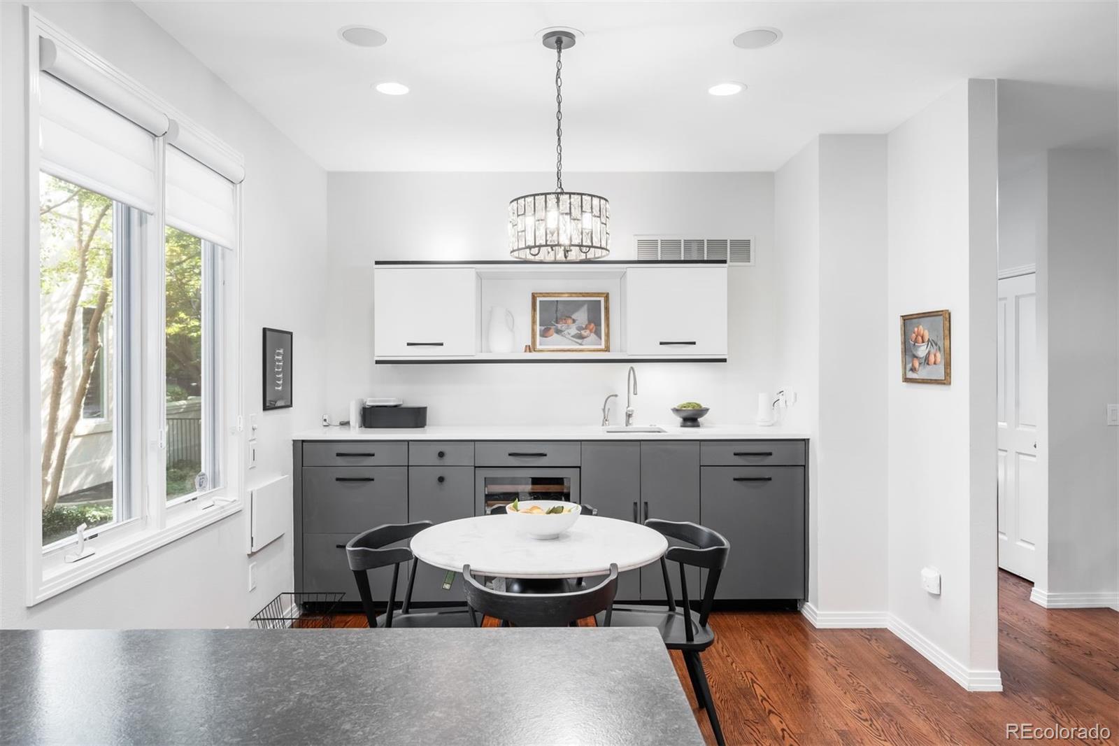 361 Detroit Street Denver, CO 80206 - Photo 15 of 46 a view of a kitchen with a table and chairs in it