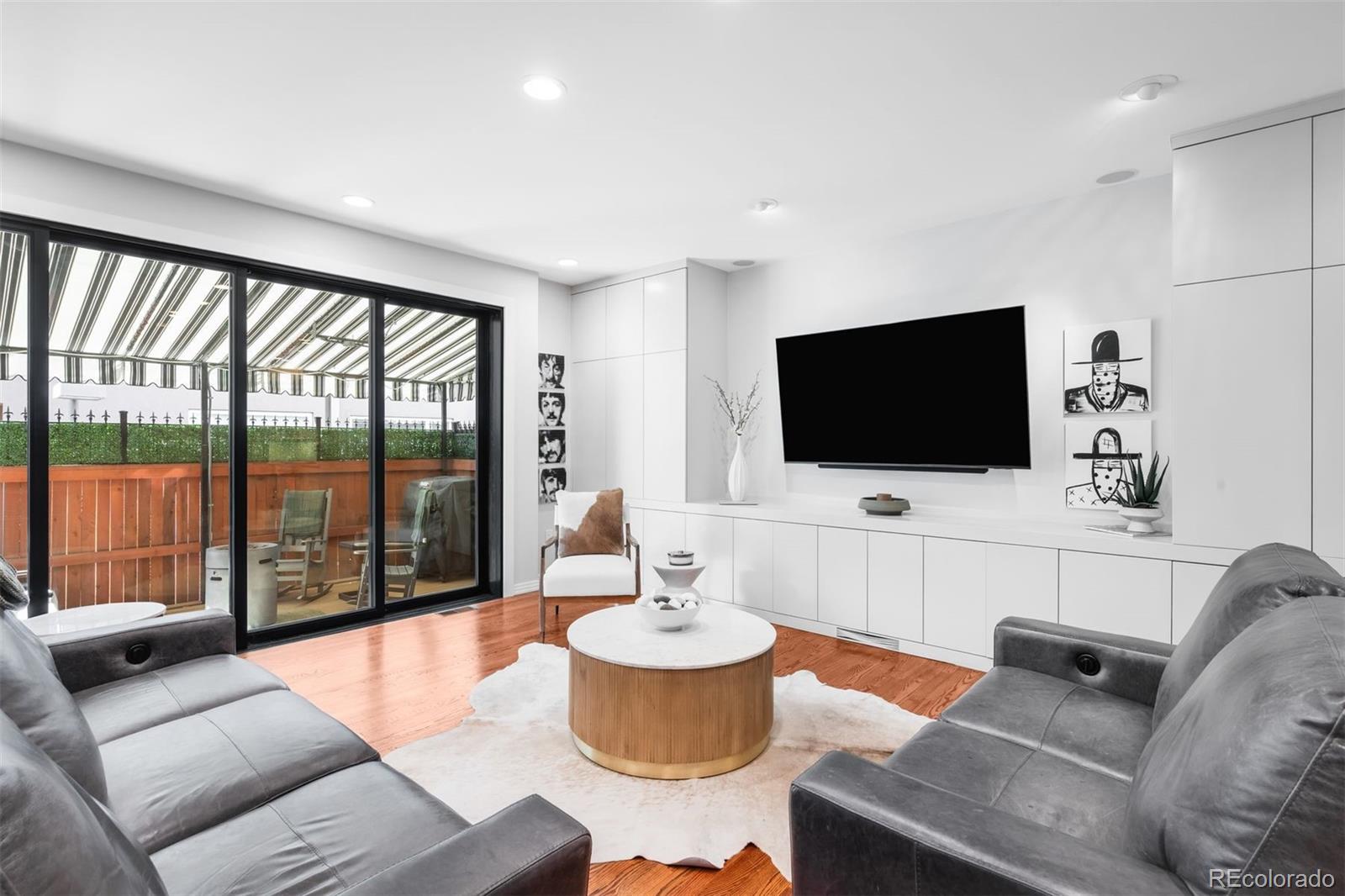 361 Detroit Street Denver, CO 80206 - Photo 21 of 46 a living room with furniture and a flat screen tv