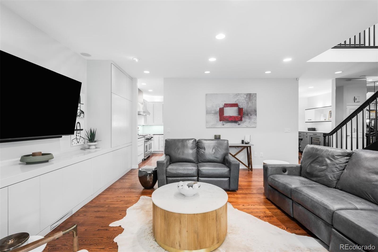 361 Detroit Street Denver, CO 80206 - Photo 23 of 46 a living room with furniture and a flat screen tv