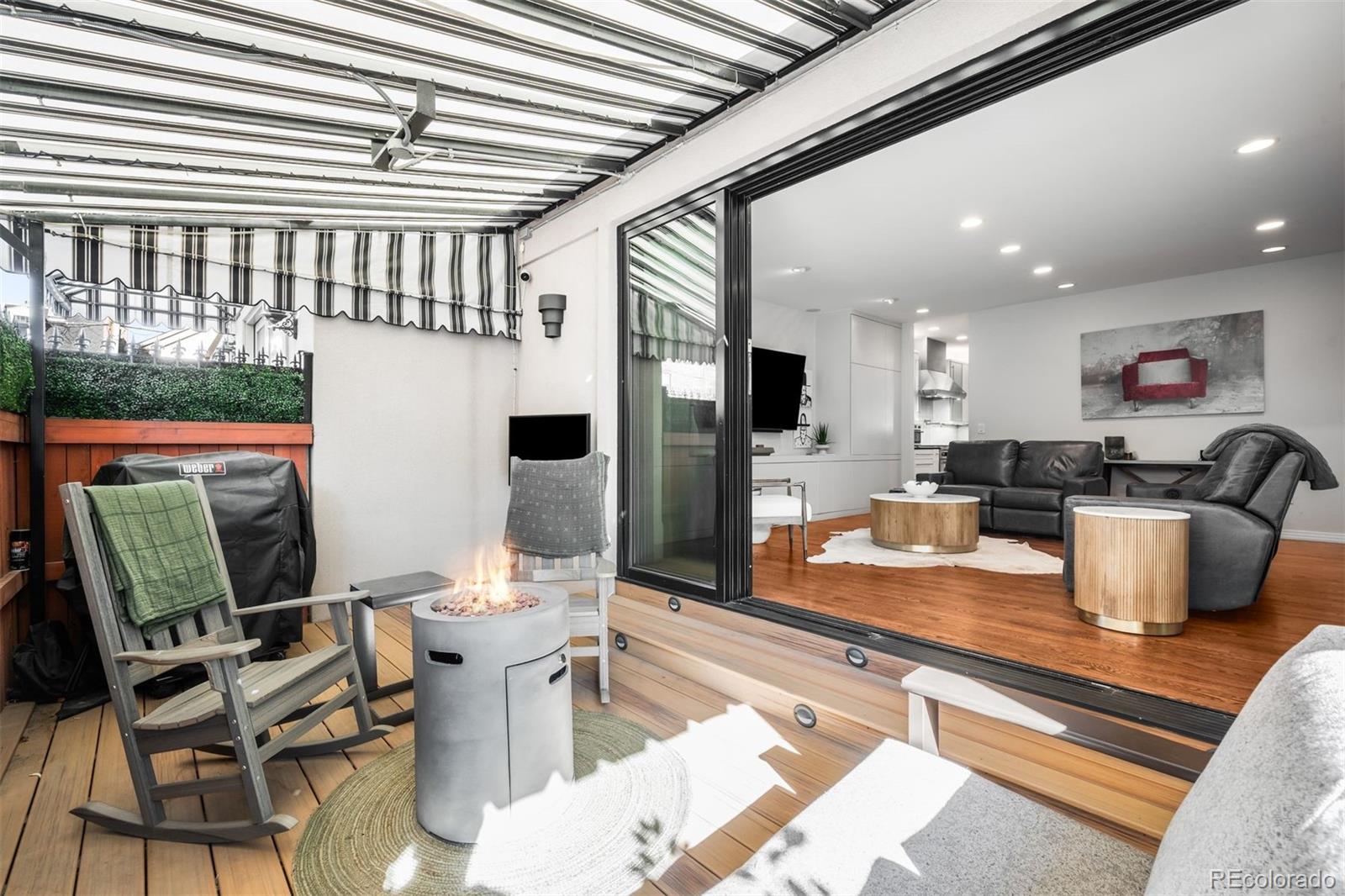 361 Detroit Street Denver, CO 80206 - Photo 24 of 46 a dining hall with stainless steel appliances granite countertop a couch and a dining table with wooden floor