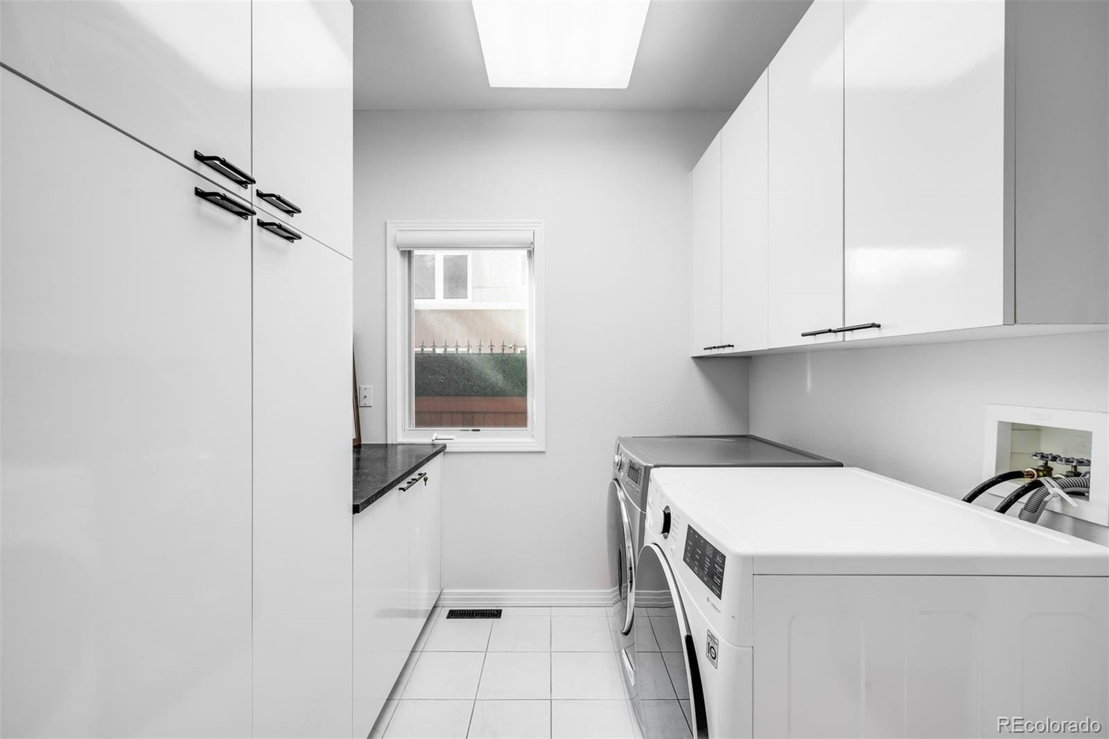 361 Detroit Street Denver, CO 80206 - Photo 26 of 46 a utility room with dryer and washer