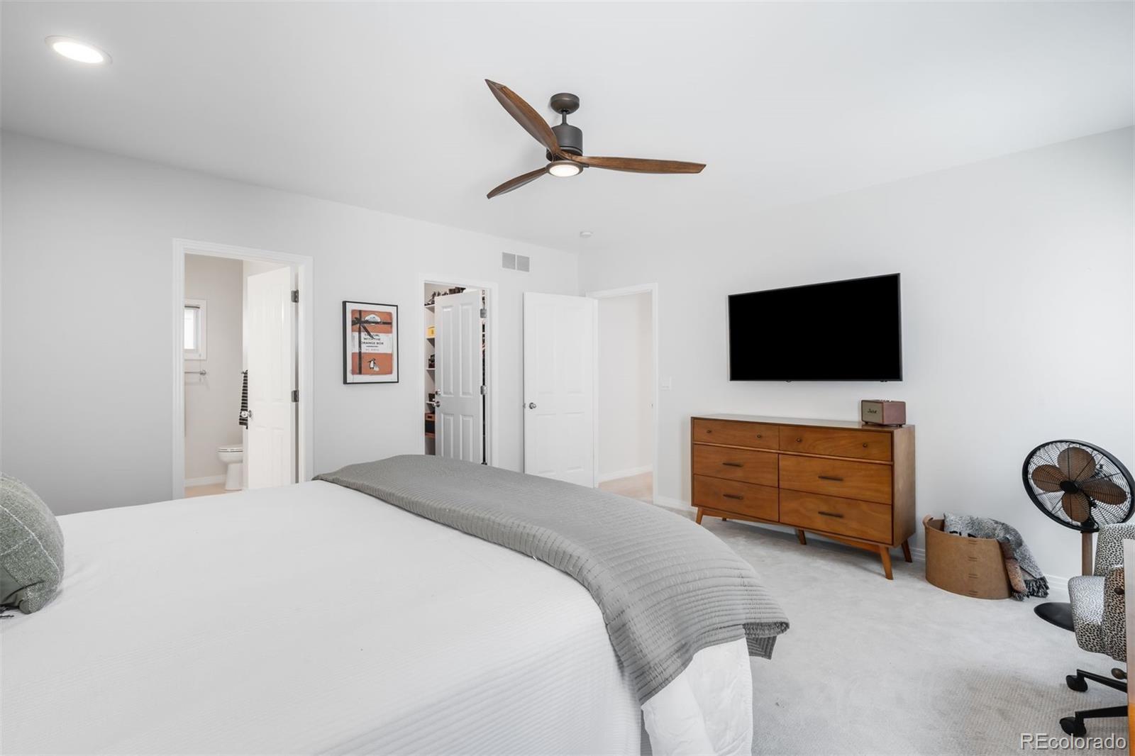 361 Detroit Street Denver, CO 80206 - Photo 28 of 46 a bedroom with a bed and flat screen tv