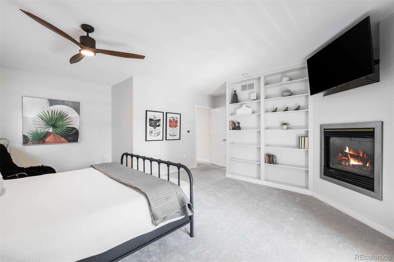 361 Detroit Street Denver, CO 80206 - Photo 31 of 46 a bedroom with a bed and a flat screen tv